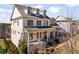 Two-story house with a gray metal roof, light brick exterior, and a two-car garage at 1045 Coleman Place Dr, Roswell, GA 30075