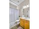 Bright bathroom featuring a shower-tub combo with neutral walls and a framed mirror at 2025 Fife Ridge Ct, Roswell, GA 30075