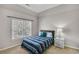 Cozy bedroom featuring a comfortable bed, with a nightstand and a large window at 2025 Fife Ridge Ct, Roswell, GA 30075
