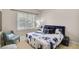 Comfortable bedroom featuring a cozy armchair and a large window with natural light at 2025 Fife Ridge Ct, Roswell, GA 30075