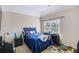 Bedroom with a blue baseball-themed comforter and large window that provides plenty of natural light at 2025 Fife Ridge Ct, Roswell, GA 30075