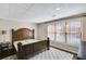 Basement bedroom with a queen sized bed, carpet, and a large window that provides plenty of natural light at 2025 Fife Ridge Ct, Roswell, GA 30075