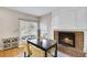 Cozy dining area with a fireplace, dining table, and natural light from the nearby window at 2025 Fife Ridge Ct, Roswell, GA 30075