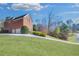 Long driveway leading to a two-car garage showcasing a sprawling lawn and mature trees at 2025 Fife Ridge Ct, Roswell, GA 30075