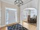 Bright entryway with hardwood floors, white wainscoting, and an arched doorway leading to the dining room at 2025 Fife Ridge Ct, Roswell, GA 30075
