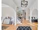Elegant foyer features hardwood floors, decorative arches, and a staircase with iron spindles at 2025 Fife Ridge Ct, Roswell, GA 30075