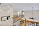 Open hallway featuring decorative railing, with natural light and sleek ceiling fan at 2025 Fife Ridge Ct, Roswell, GA 30075