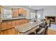 Bright kitchen with a breakfast bar, stainless appliances, and cabinetry, adjacent to a cozy dining area at 2025 Fife Ridge Ct, Roswell, GA 30075