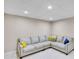 Basement living room featuring a large sectional couch with throw pillows and recessed ceiling lights at 2025 Fife Ridge Ct, Roswell, GA 30075