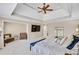 Spacious main bedroom featuring tray ceiling, sitting area, and a large bed at 2025 Fife Ridge Ct, Roswell, GA 30075