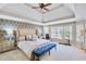 This is a spacious main bedroom, featuring tray ceiling, large windows, and a stylish accent wall at 2025 Fife Ridge Ct, Roswell, GA 30075