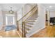 Elegant staircase with wood treads, iron balusters, and stylish runner in a well-lit foyer at 2025 Fife Ridge Ct, Roswell, GA 30075