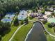 Aerial view shows tennis courts, clubhouse, pool and landscaping at 918 Big Horn Holw, Suwanee, GA 30024