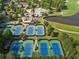 Aerial view of the community featuring tennis courts, clubhouse, and swimming pool at 918 Big Horn Holw, Suwanee, GA 30024