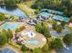 Aerial view showcases community amenities: pool, tennis courts, clubhouse, and playground at 918 Big Horn Holw, Suwanee, GA 30024