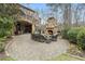 Beautiful backyard with a stone patio, fireplace, and lush landscaping at 918 Big Horn Holw, Suwanee, GA 30024