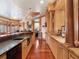 Spacious bar area featuring wooden cabinets, granite countertops, and hardwood floors at 918 Big Horn Holw, Suwanee, GA 30024