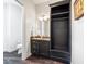 Elegant half-bathroom with dark wood vanity, black shelving, and a toilet at 918 Big Horn Holw, Suwanee, GA 30024