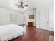 Spacious bedroom with hardwood floors, neutral walls, and a ceiling fan for comfort at 918 Big Horn Holw, Suwanee, GA 30024