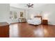 Large bedroom with hardwood floors, natural light, seating, and a spacious layout at 918 Big Horn Holw, Suwanee, GA 30024