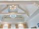 Intricate ceiling design with exposed beams and a stunning chandelier, adding architectural interest and elegance to the home at 918 Big Horn Holw, Suwanee, GA 30024