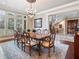Formal dining room featuring a chandelier and large windows with elegant shutters at 918 Big Horn Holw, Suwanee, GA 30024