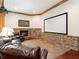 Entertainment area with a large screen, fireplace, and seating for enjoying movies and gatherings at 918 Big Horn Holw, Suwanee, GA 30024