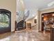 Grand foyer with a curved staircase, elegant tile flooring, and decorative iron accents at 918 Big Horn Holw, Suwanee, GA 30024