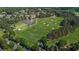Aerial view of a lush green golf course surrounded by trees and a pond in a residential area at 918 Big Horn Holw, Suwanee, GA 30024