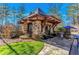 Charming stone guard house with a peaked roof and manicured landscaping at 918 Big Horn Holw, Suwanee, GA 30024