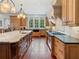 Gourmet kitchen features a large center island, custom cabinets, and professional-grade appliances at 918 Big Horn Holw, Suwanee, GA 30024