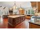 Gourmet kitchen features a large center island, custom cabinets, and high-end appliances at 918 Big Horn Holw, Suwanee, GA 30024