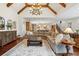 Spacious living room features a large sectional sofa and chandelier with hardwood floors at 918 Big Horn Holw, Suwanee, GA 30024