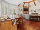 Open concept living area with a stone fireplace, wood beams, and an adjacent dining area at 918 Big Horn Holw, Suwanee, GA 30024