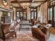 Cozy living room with brick fireplace, exposed beams, and comfortable leather seating at 918 Big Horn Holw, Suwanee, GA 30024