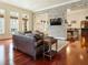 Inviting living room with a brick wall, fireplace, hardwood floors, and natural light at 918 Big Horn Holw, Suwanee, GA 30024
