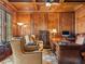 Executive office features wood paneled walls, coffered ceiling, and custom built-in desk and cabinets at 918 Big Horn Holw, Suwanee, GA 30024
