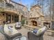 Cozy outdoor space with stone fireplace, comfortable seating, and elegant stonework at 918 Big Horn Holw, Suwanee, GA 30024