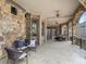 Expansive covered patio featuring stone accents, ceiling fans, and ample seating, perfect for outdoor relaxation and entertainment at 918 Big Horn Holw, Suwanee, GA 30024