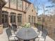 Rear patio featuring an elegant outdoor dining set and comfortable seating, ideal for entertaining guests and enjoying the outdoors at 918 Big Horn Holw, Suwanee, GA 30024