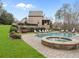 Backyard featuring a serene pool, stone-encased hot tub, and beautifully landscaped surroundings at 918 Big Horn Holw, Suwanee, GA 30024