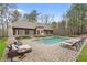 Relaxing poolside setting with comfortable lounge chairs, umbrella, and lush greenery at 918 Big Horn Holw, Suwanee, GA 30024