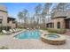 Inviting pool area with lounge chairs, hot tub, and meticulously designed patio at 918 Big Horn Holw, Suwanee, GA 30024