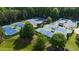 Overhead shot of multiple tennis courts, trees and green space at 918 Big Horn Holw, Suwanee, GA 30024