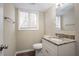 Updated bathroom with granite countertop, white vanity, and vinyl flooring at 2211 Green Forrest Dr, Decatur, GA 30032