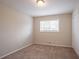 Well-lit bedroom with neutral walls, brown carpet, and double-door closet at 2211 Green Forrest Dr, Decatur, GA 30032