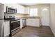 Renovated kitchen with stainless steel appliances and granite countertops at 2211 Green Forrest Dr, Decatur, GA 30032