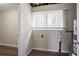 Bright laundry room with washer and dryer hookups, vinyl flooring, and window at 2211 Green Forrest Dr, Decatur, GA 30032