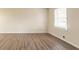 Living room with hardwood-look vinyl flooring and large window at 2211 Green Forrest Dr, Decatur, GA 30032