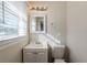 Small bathroom with a vanity, toilet, and window at 3582 Swallow Ln, Decatur, GA 30032